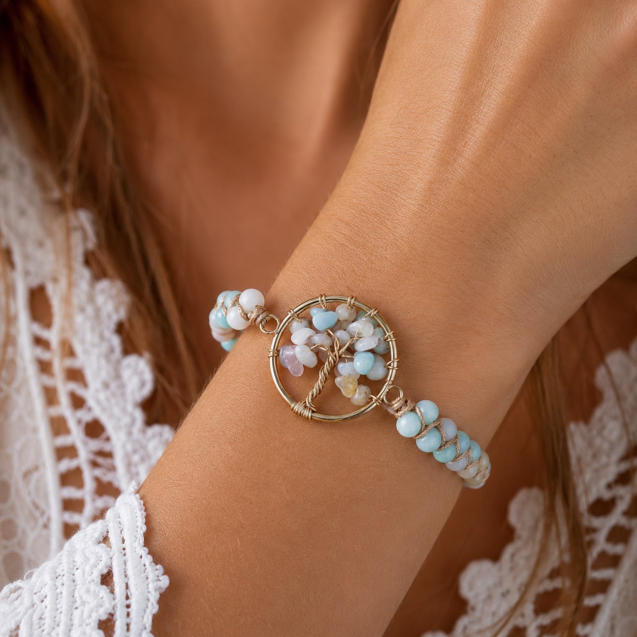 Woman wearing the Amazonite Tree Of Life Bracelet featuring natural amazonite beads and a gold-tone tree of life centerpiece with gemstone accents.