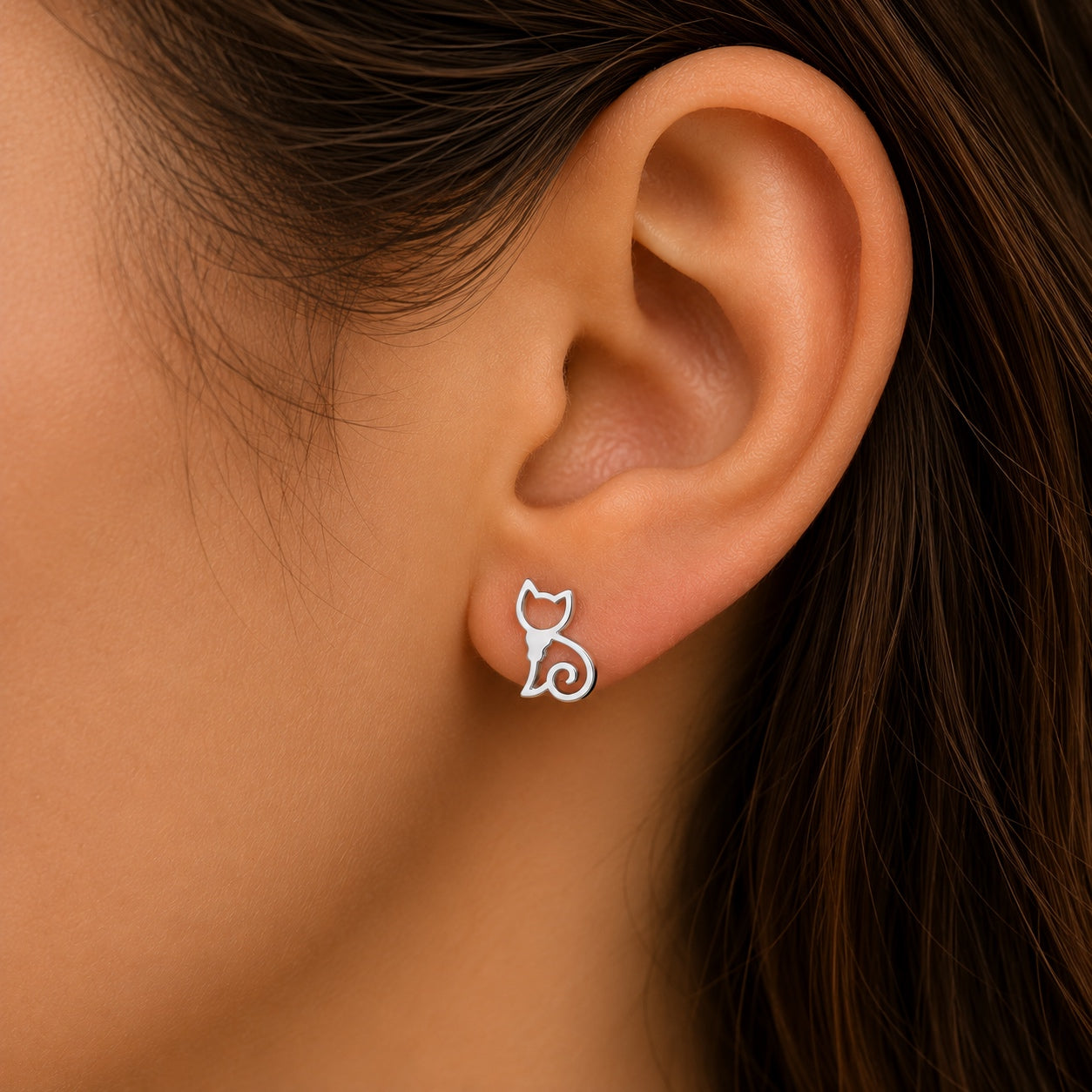 Woman wearing silver cat stud earrings featuring a minimalist cat silhouette for everyday wear.