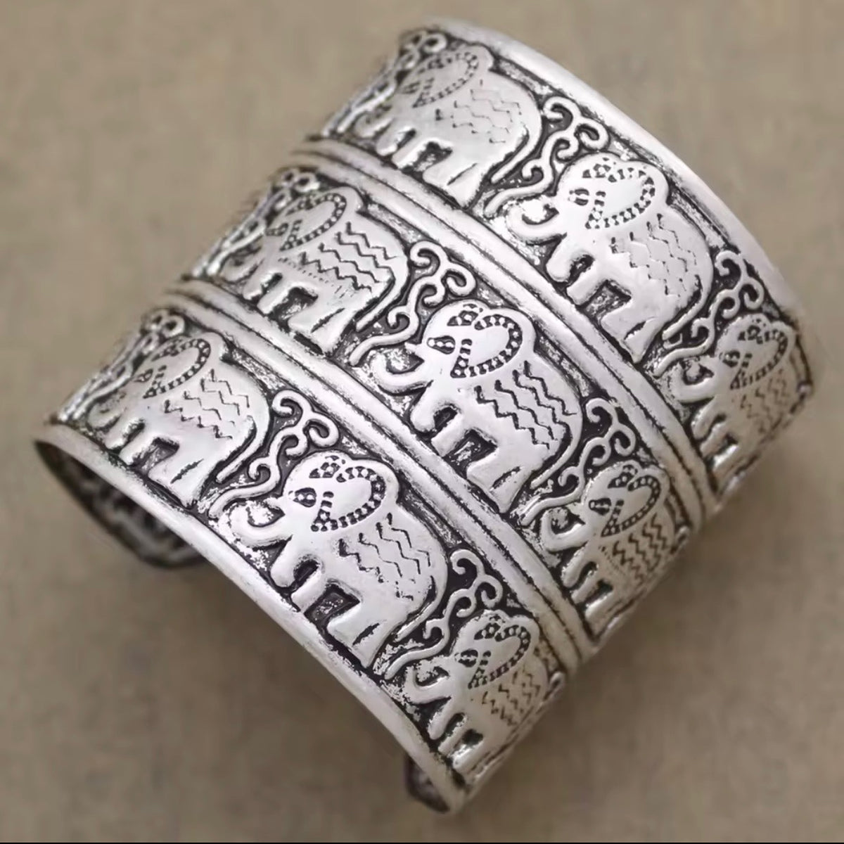 Close-up of the Elephant Cuff Bracelet featuring detailed engraved elephants and antique silver finish.