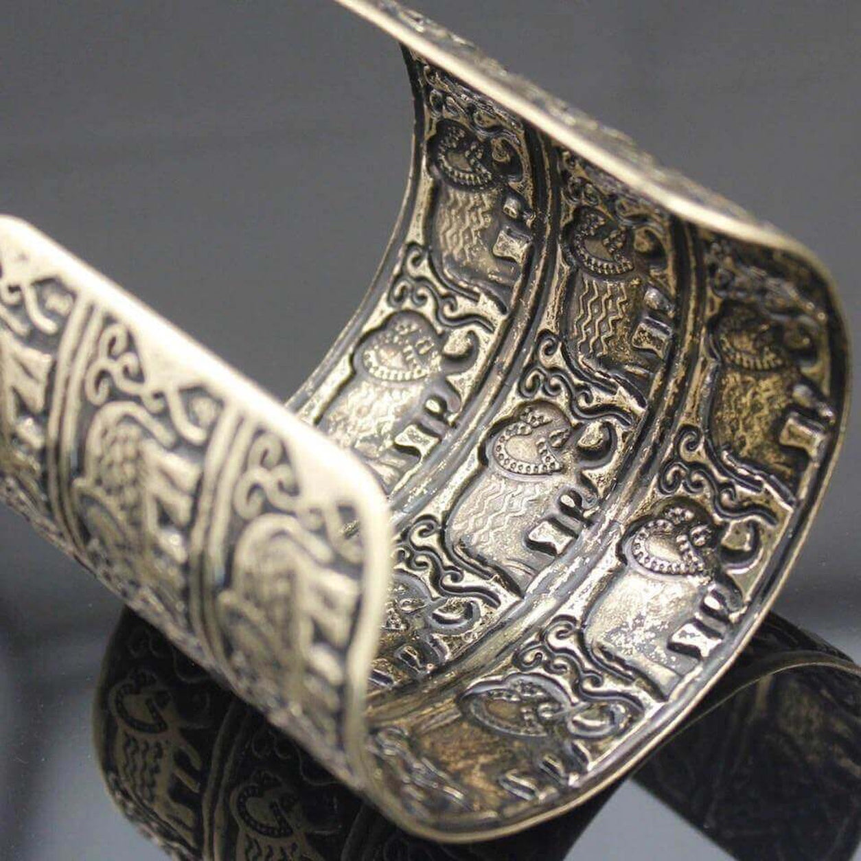 Interior view of the Elephant Cuff Bracelet showing engraved elephant details and antique gold craftsmanship.