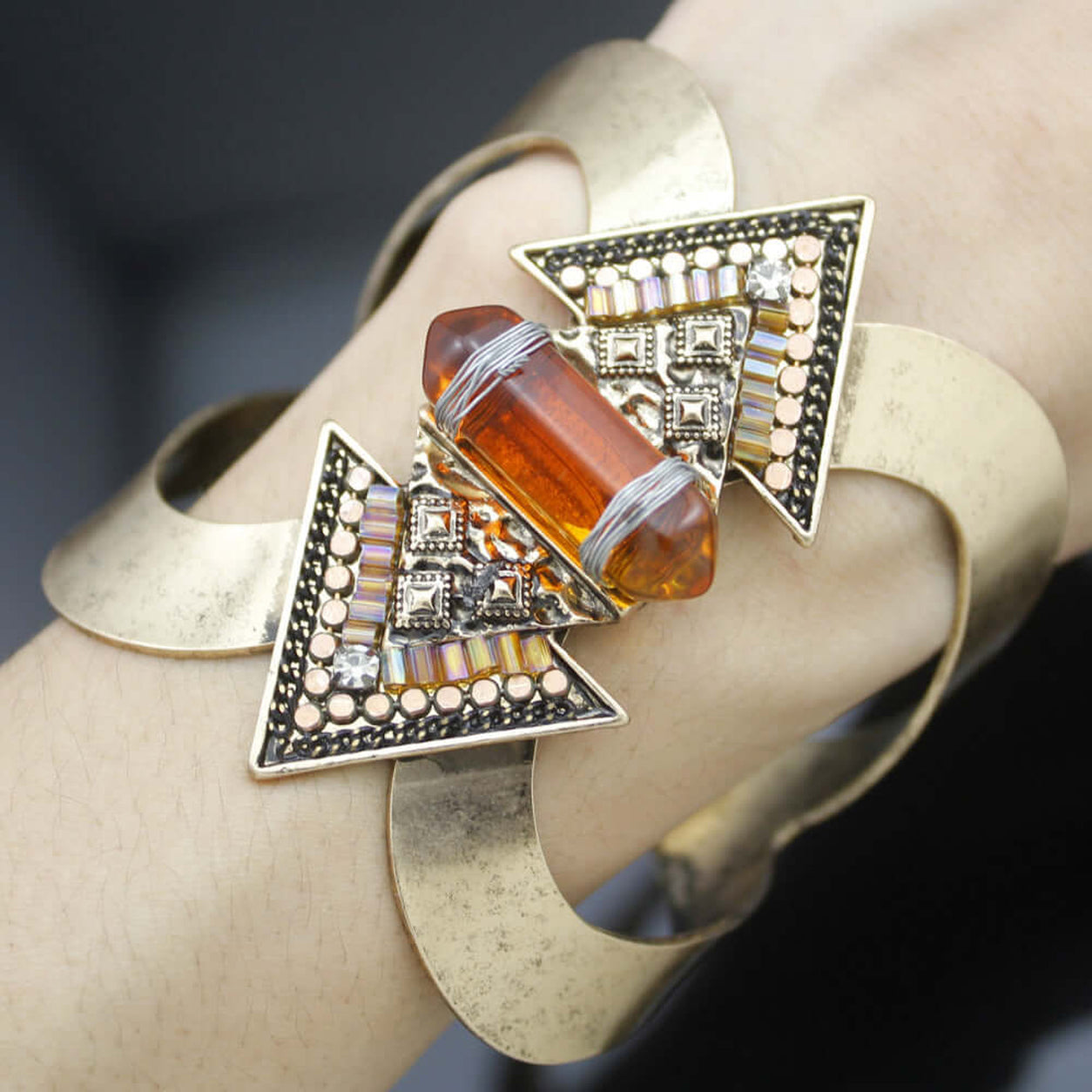 Close-up of the Geometric Crystal Cuff Bracelet worn on the wrist featuring a wide antique gold cuff and geometric crystal design.