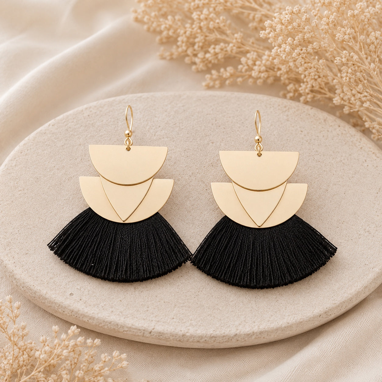 Black Geometric Fan Tassel Earrings featuring layered gold geometric shapes and flowing black fan tassels.