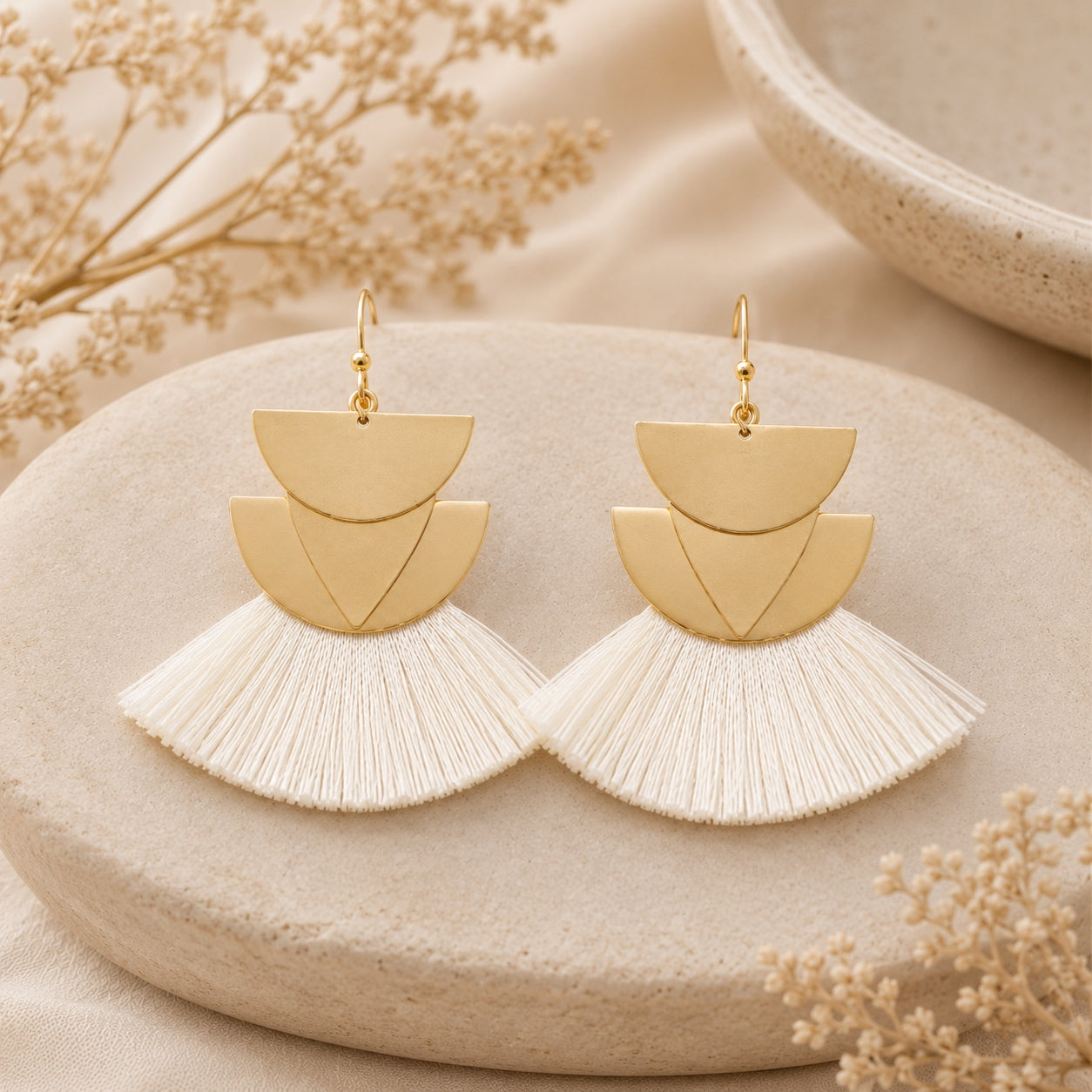White Geometric Fan Tassel Earrings featuring layered gold geometric shapes and soft white fan tassels.
