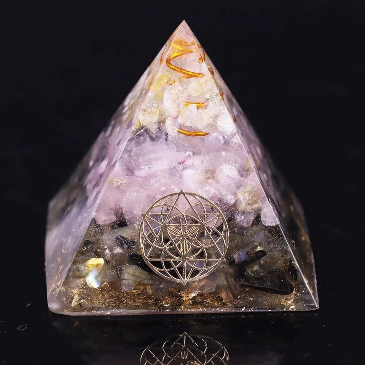 Rose Quartz & Labradorite Crystal Pyramid with copper coil and sacred geometry symbol on a black background.