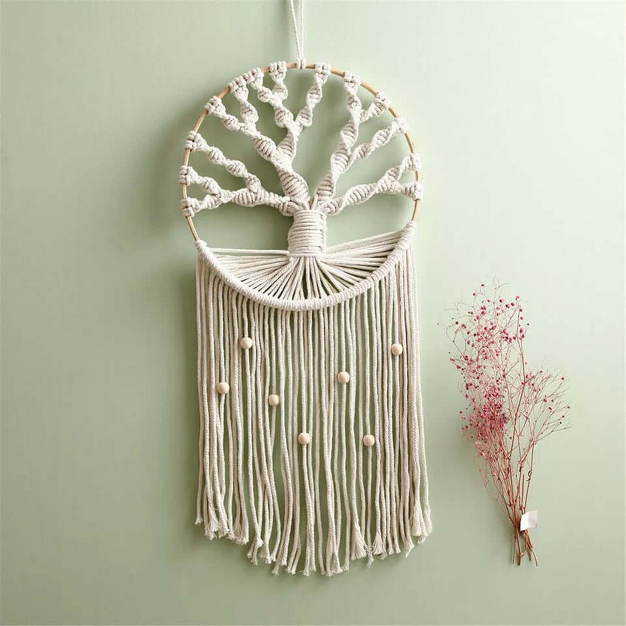 Tree Of Life Macrame Wall Hanging displayed on a sage green wall as boho home decor.