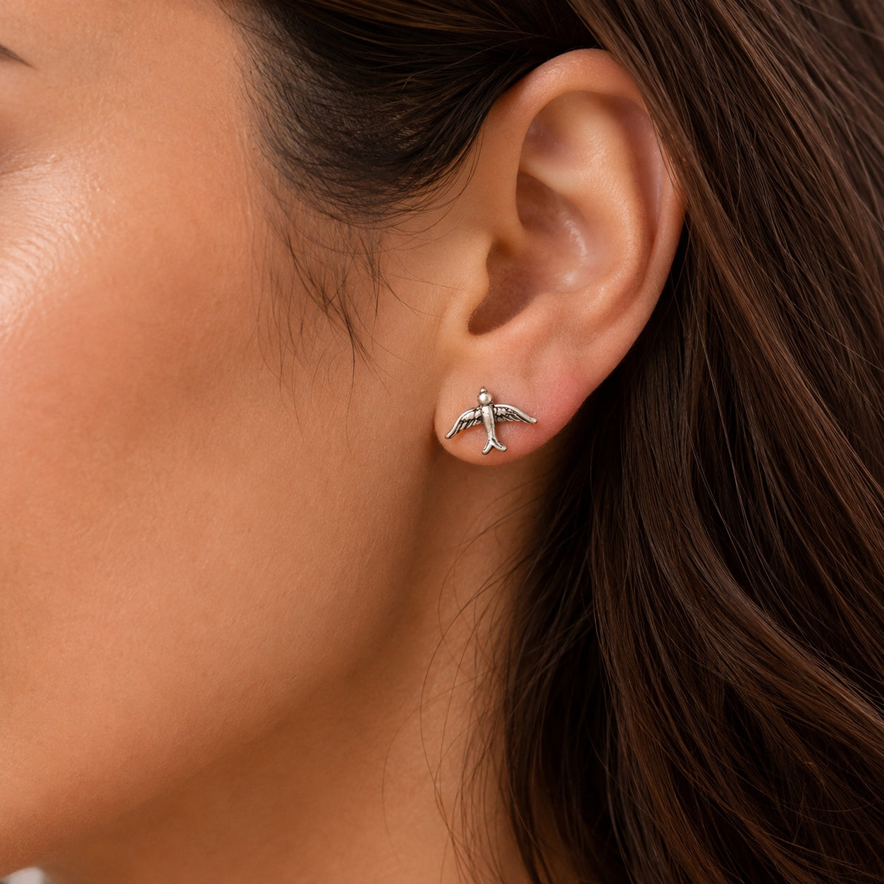 Vintage Silver Bird Stud Earrings worn on ear showing delicate everyday fit and minimalist style.