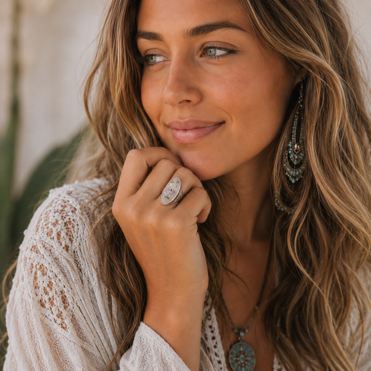 Woman wearing the Abalone Shell Statement Ring with boho jewelry, showcasing the oversized iridescent shell design.