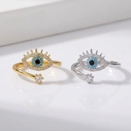 All Seeing Eye Ring shown in gold and silver finishes with turquoise evil eye and sparkling crystal accents.