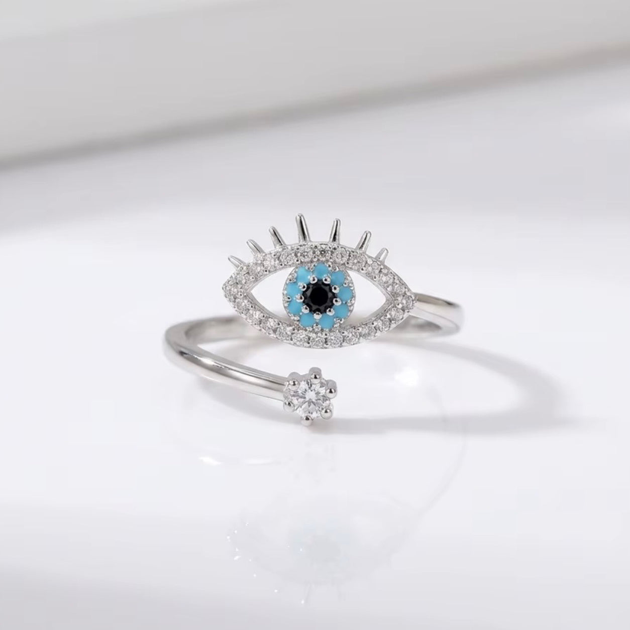 Silver All Seeing Eye Ring with turquoise evil eye centerpiece, crystal details, and an adjustable open band.