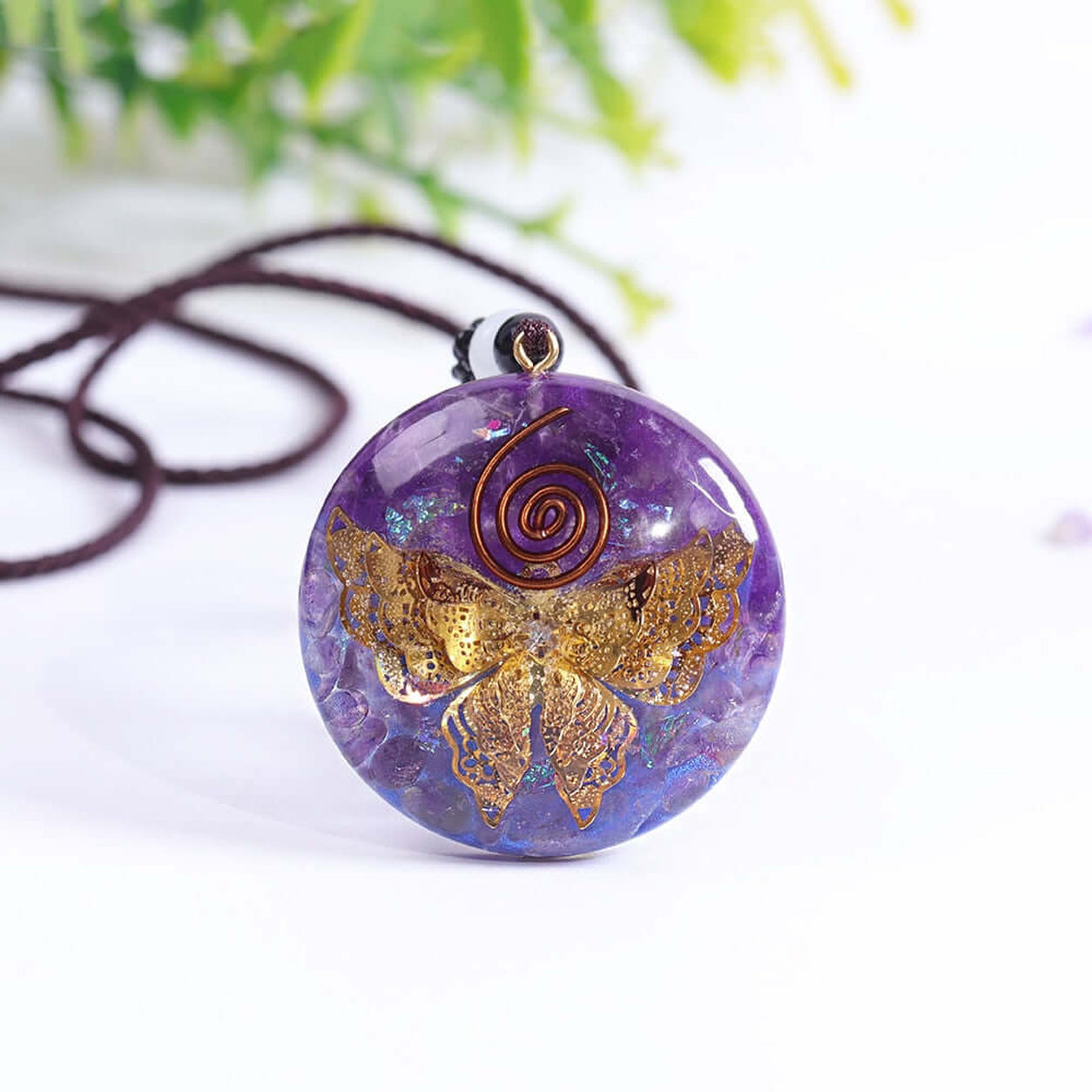 Amethyst Butterfly Pendant Necklace with a gold butterfly inside a polished purple crystal pendant displayed on a soft white background.