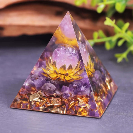 Amethyst Lotus Crystal Pyramid with gold lotus, amethyst sphere, copper, and gold foil displayed on a tabletop.