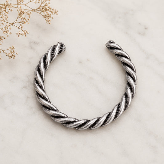 Antique Silver Coil Cuff Bracelet on a marble display with a rustic boho jewelry styling.