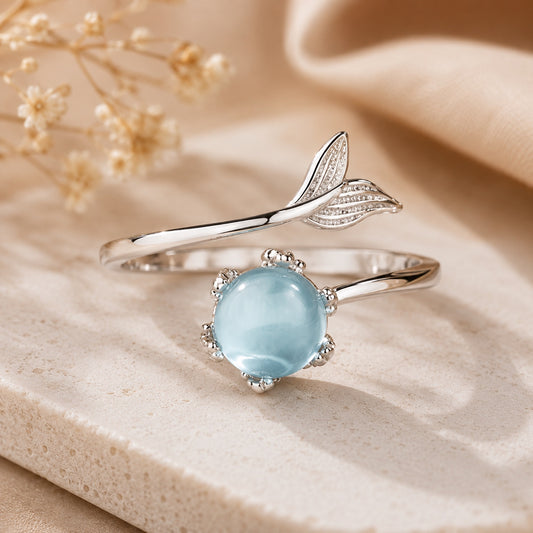 Blue Crystal Mermaid Ring featuring a shimmering round blue crystal on an adjustable silver mermaid tail band.