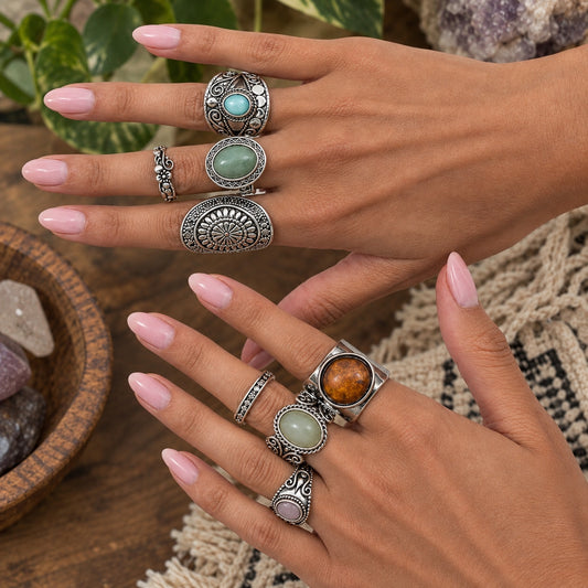 Ornate silver Bohemian Wanderer rings with turquoise, green, amber, and pink stones worn on both hands