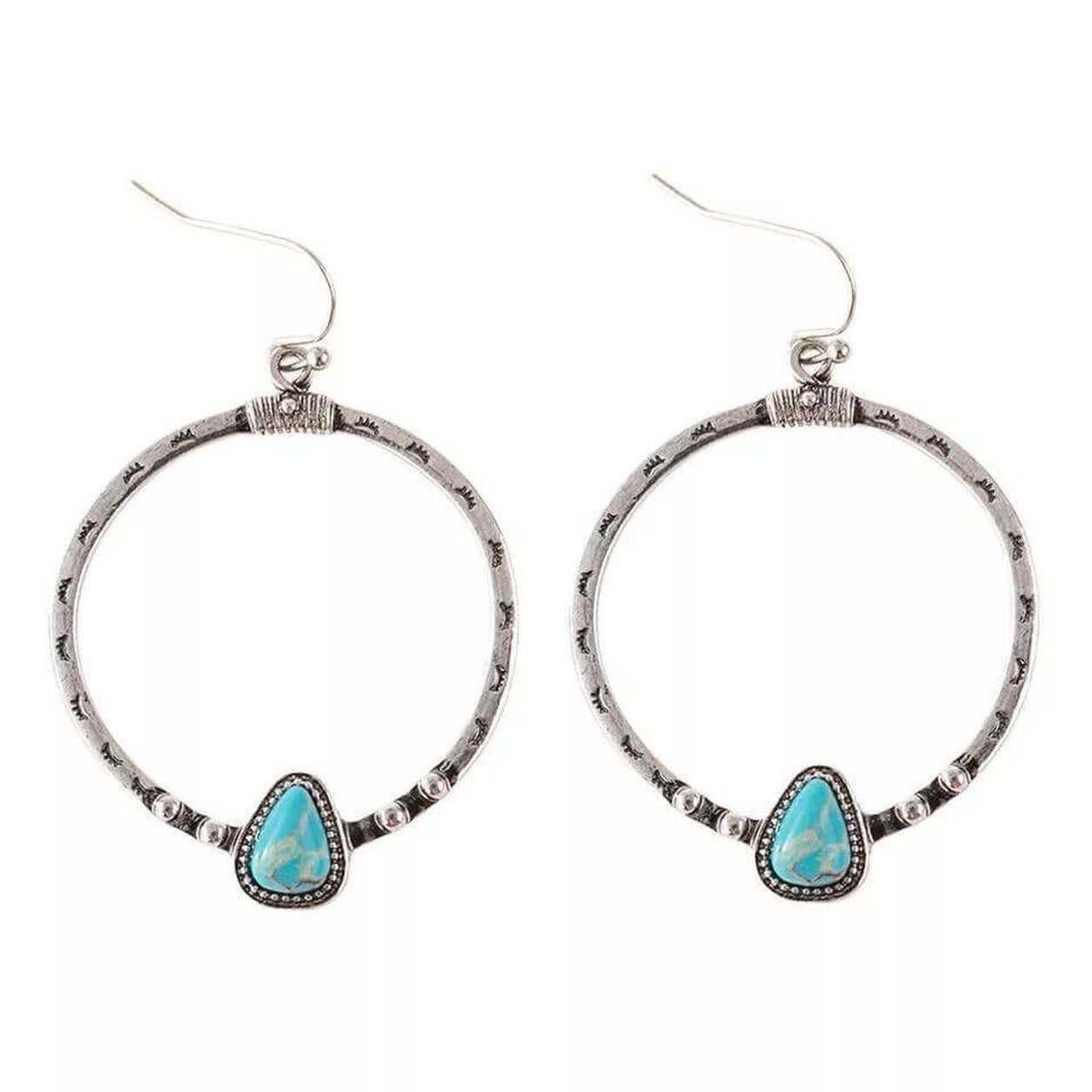 Canyonlands Hoop Earrings with engraved silver hoops and turquoise teardrop stones on a white background.