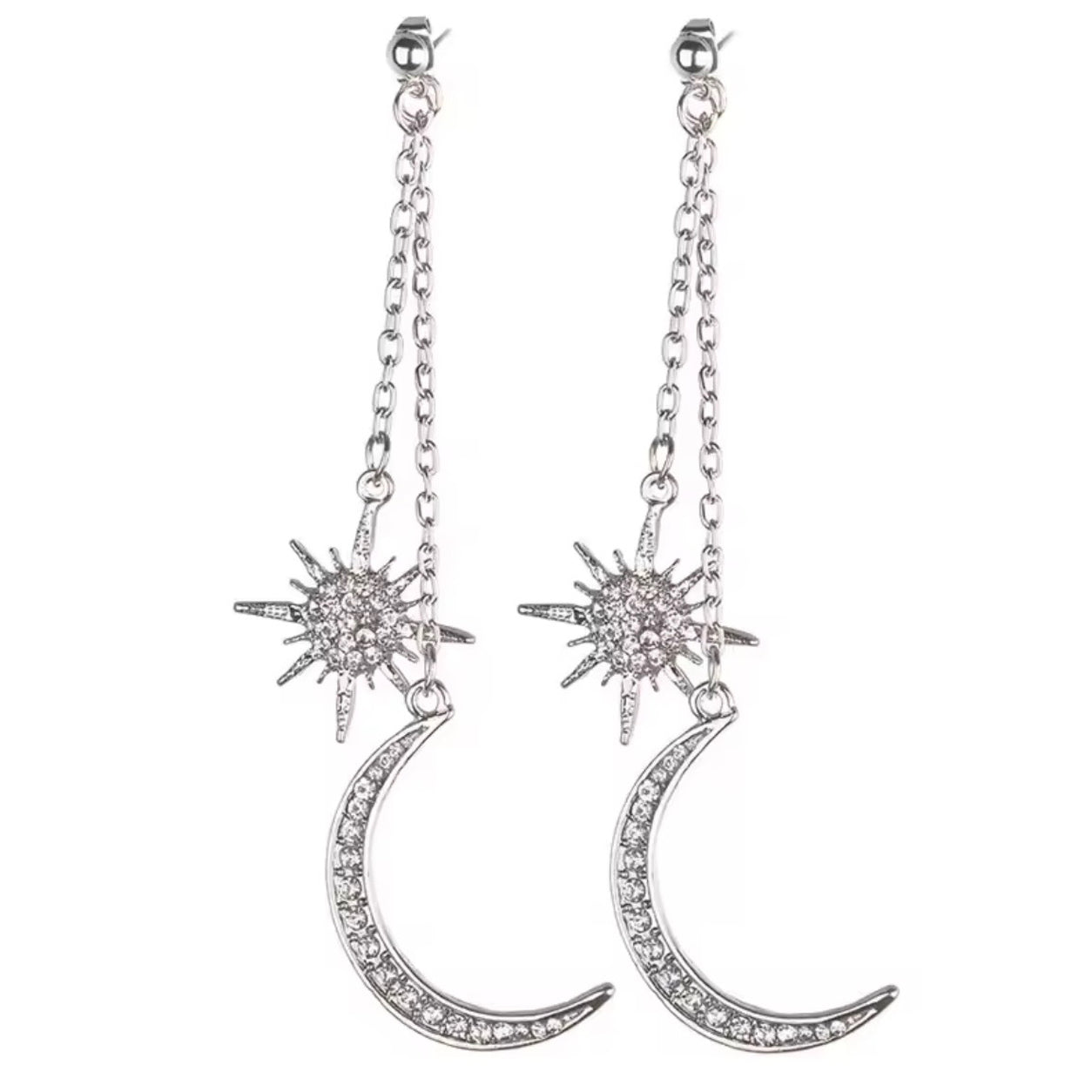 Silver Celestial Dangle Earrings featuring sparkling starburst and crescent moon charms isolated on a white background.