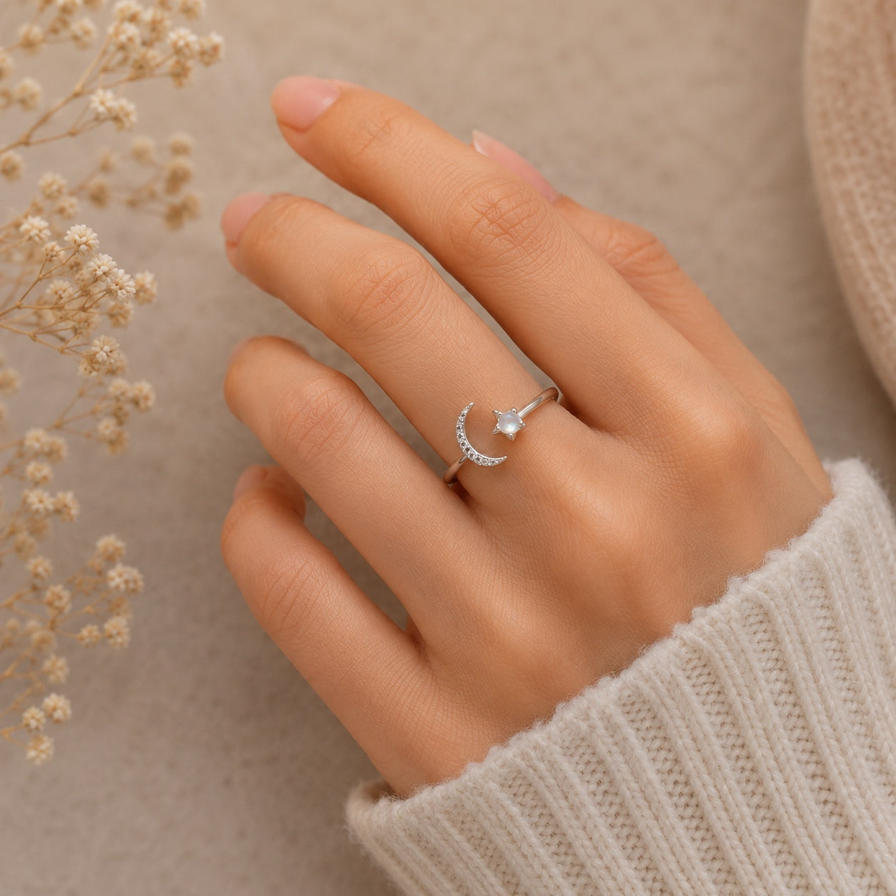 Woman wearing the Celestial Moonstone Ring featuring a crescent moon and moonstone gemstone in sterling silver.