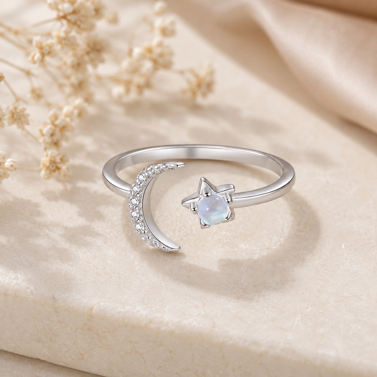 Side view of the Celestial Moonstone Ring featuring a sparkling crescent moon and glowing moonstone in sterling silver.