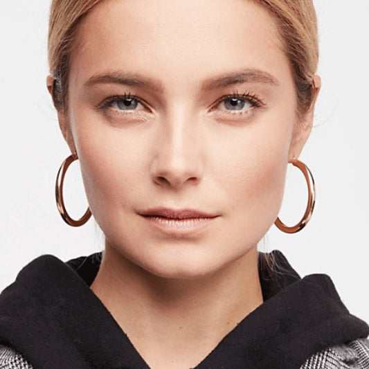 Woman wearing Classic Hoop Earrings in polished gold with a timeless minimalist design.