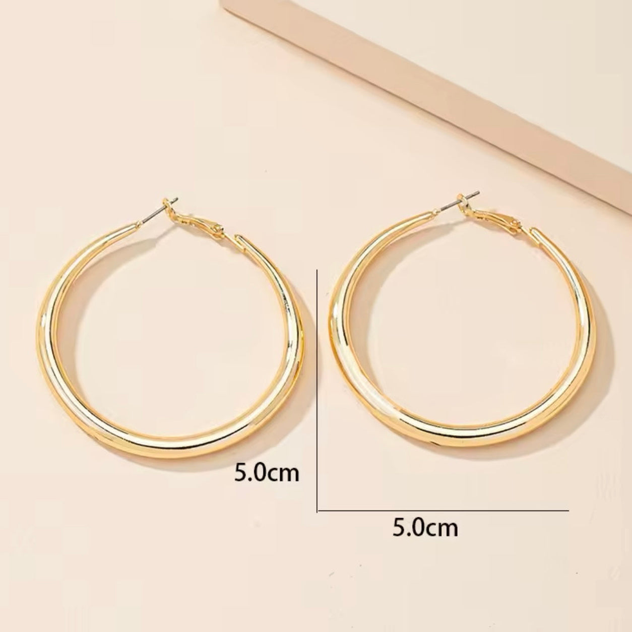 Classic Hoop Earrings in gold with 5 cm size reference, lightweight oversized hoop earrings with a polished finish.