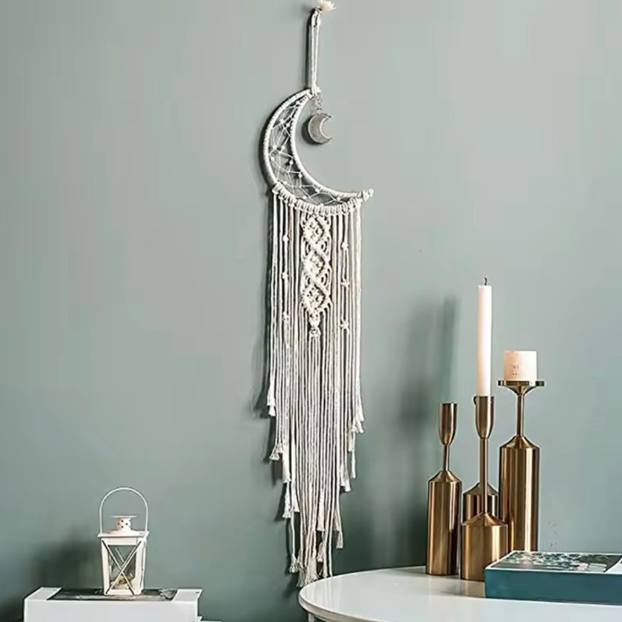Crescent Moon Macrame Wall Hanging decorating a modern living space with candles and minimalist bohemian home décor.