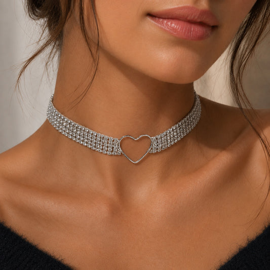 Woman wearing the Crystal Heart Choker Necklace featuring sparkling rhinestones and an open heart centerpiece in a close-up fashion portrait.