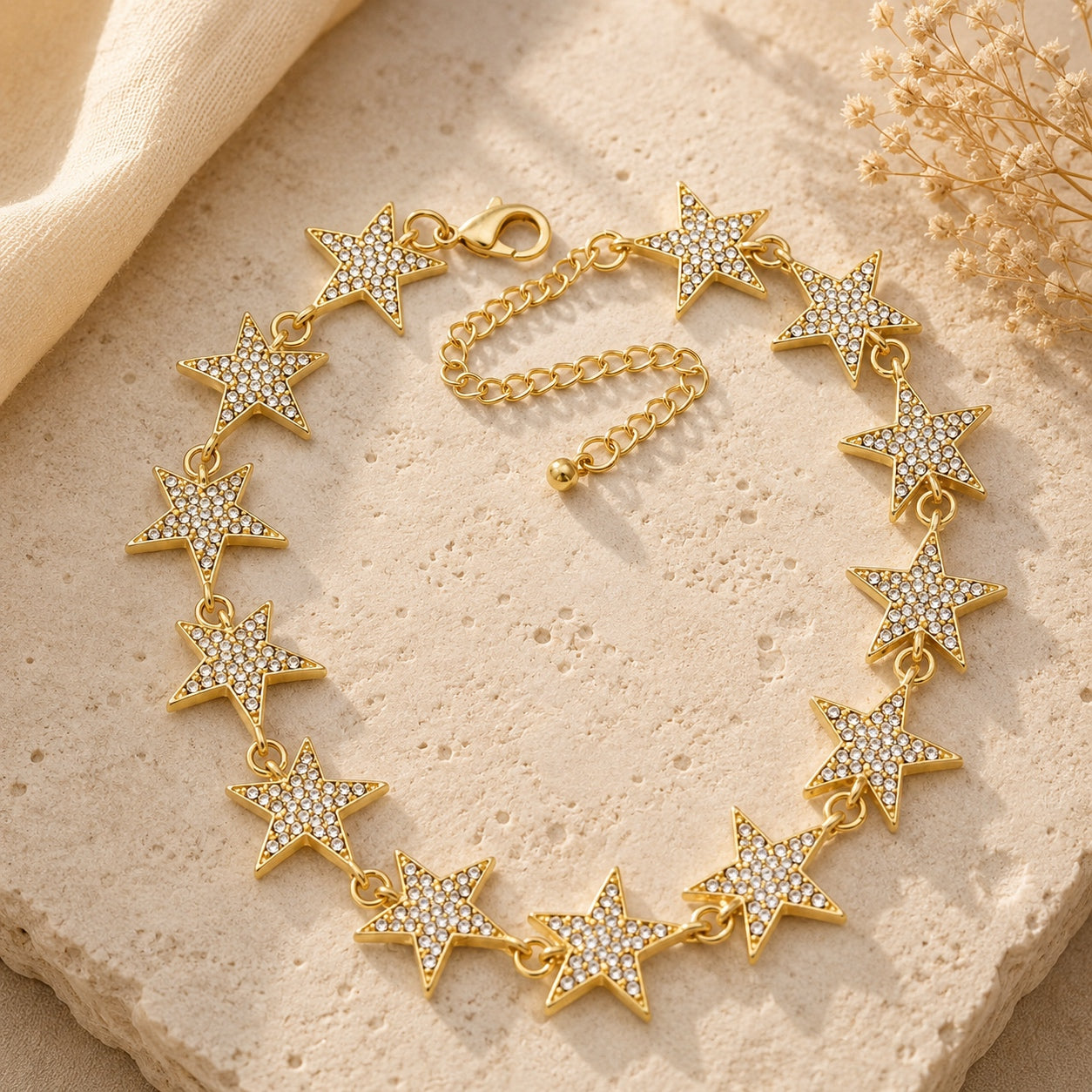 Gold Crystal Star Collar Necklace with sparkling crystal stars arranged on a neutral textured background for luxury jewelry photography.