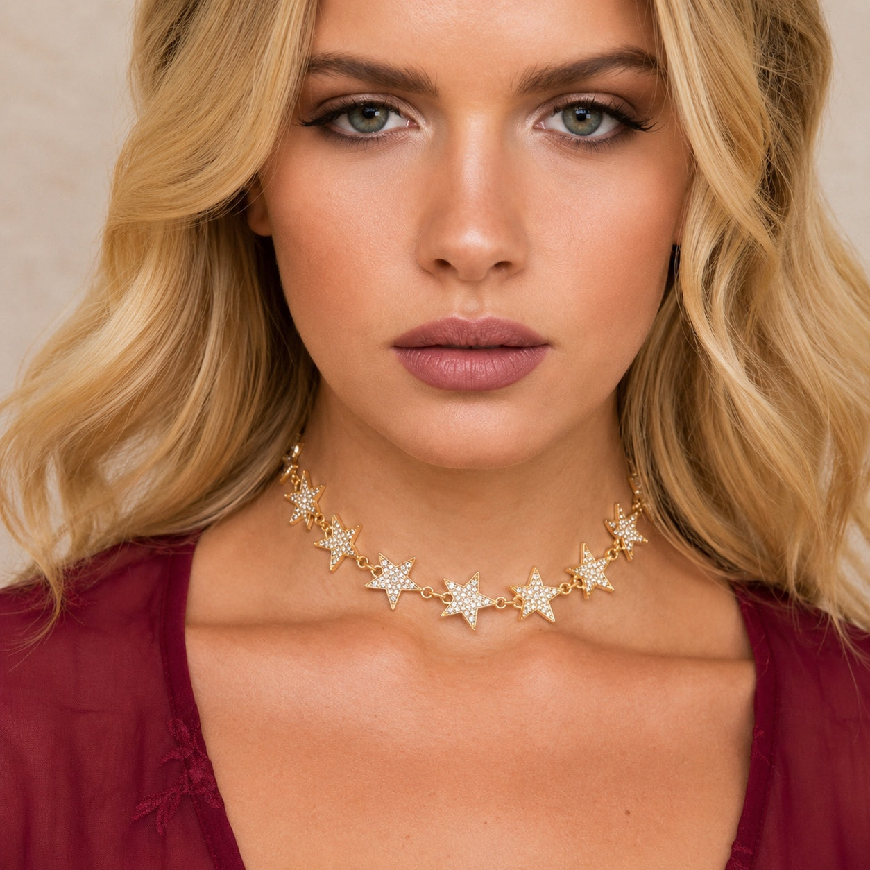 Gold Crystal Star Collar Necklace featuring shimmering crystal star charms worn close to the neck for an elegant celestial look.