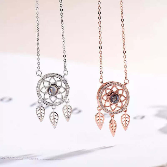 Dreamcatcher Necklace available in silver and rose gold finishes with crystal accents and leaf charms.