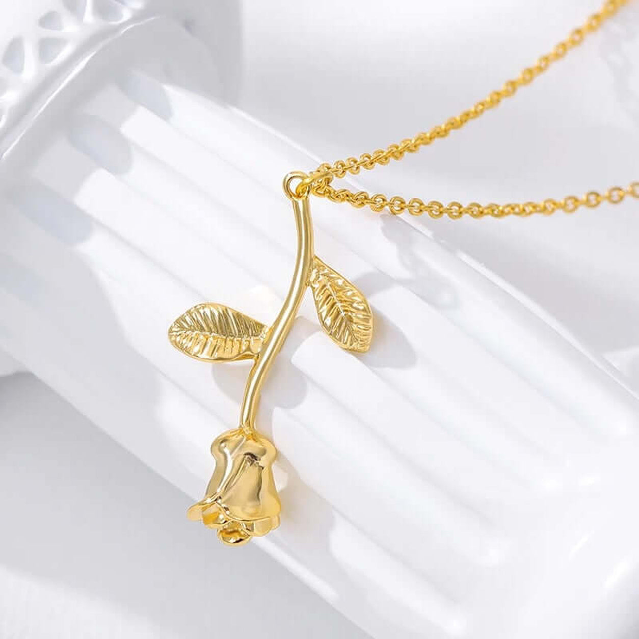 Close-up product image of the Elegant Rose Pendant Necklace in polished gold with detailed leaf accents.
