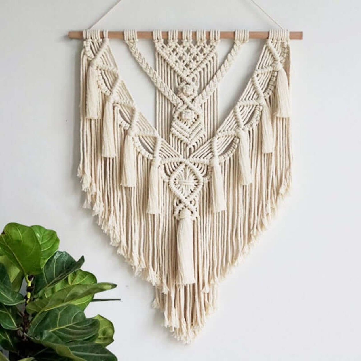 Elegant Tassels Macrame Wall Hanging handcrafted from natural cotton cord, displayed as boho wall decor with decorative tassels.