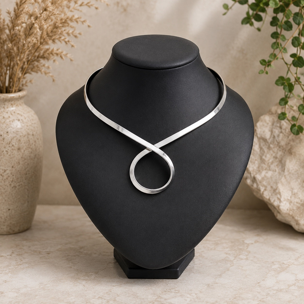 Enchantress Torque Collar Necklace in silver featuring a modern torque collar and circular centerpiece.