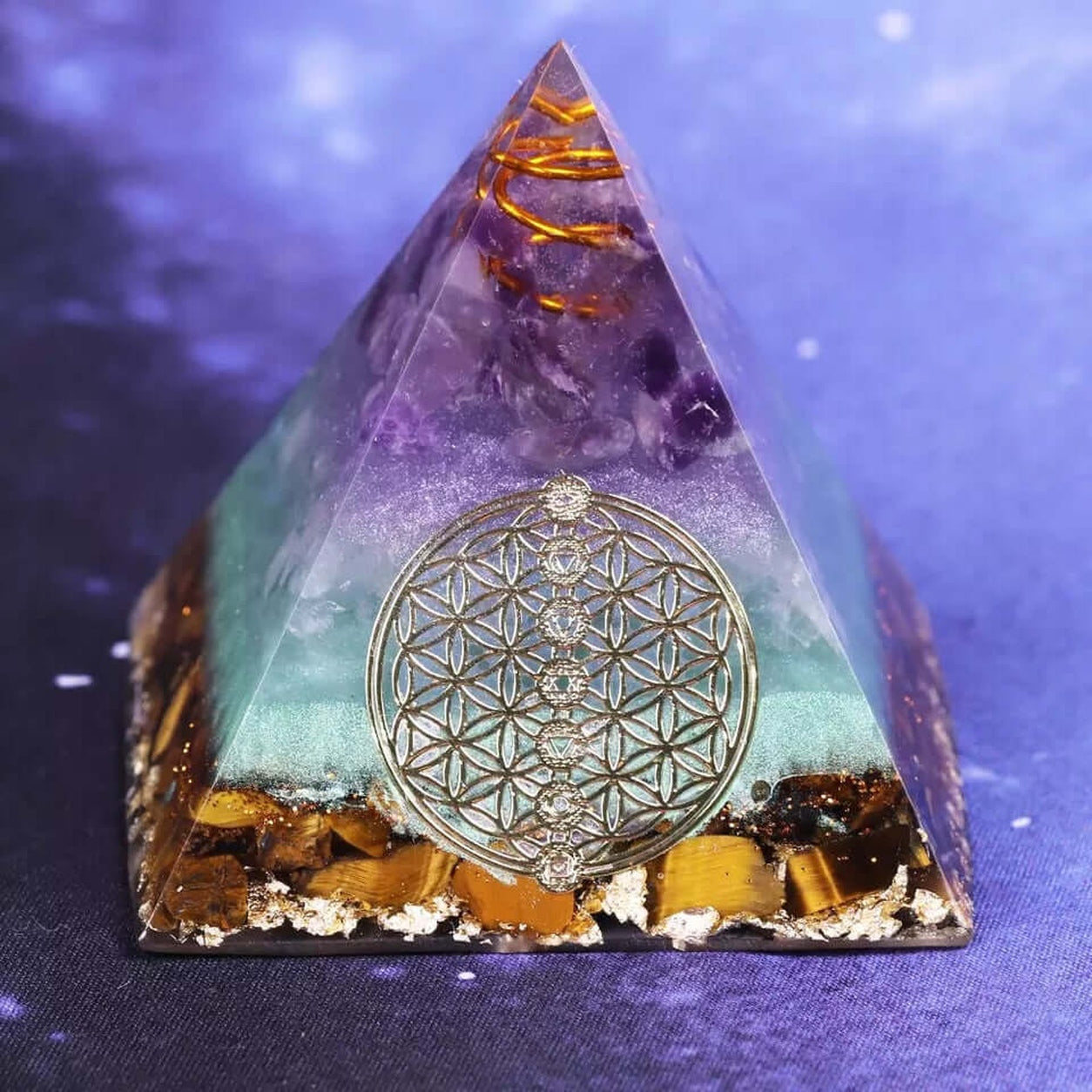 Flower of Life Crystal Pyramid featuring amethyst, turquoise resin, tiger eye stones, copper coil, and sacred geometry emblem.