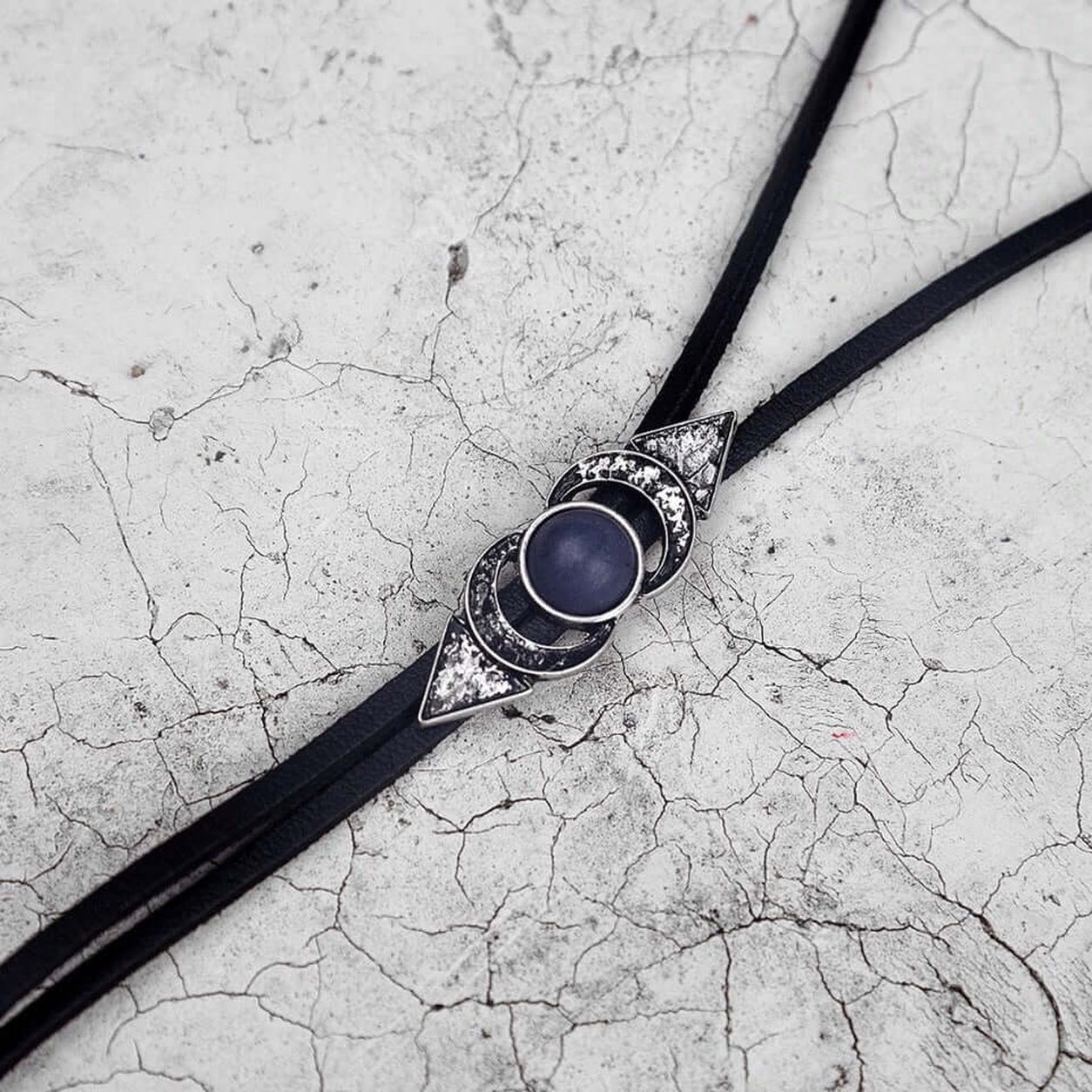 Close-up of the Geometric Bolo Necklace adjustable slide featuring celestial moon-inspired metal detailing.