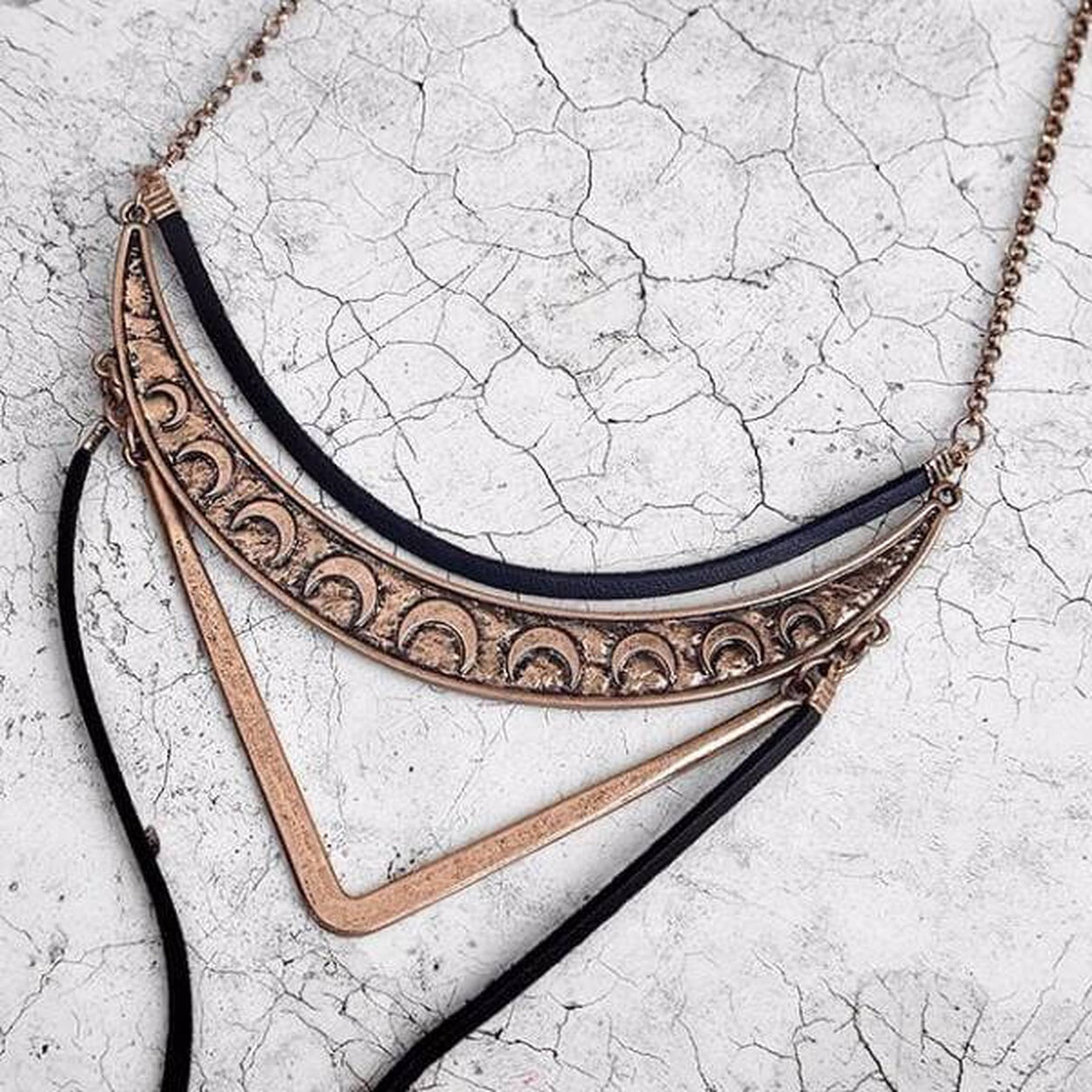 Antique bronze Geometric Bolo Necklace with layered geometric pendant and adjustable black cord.