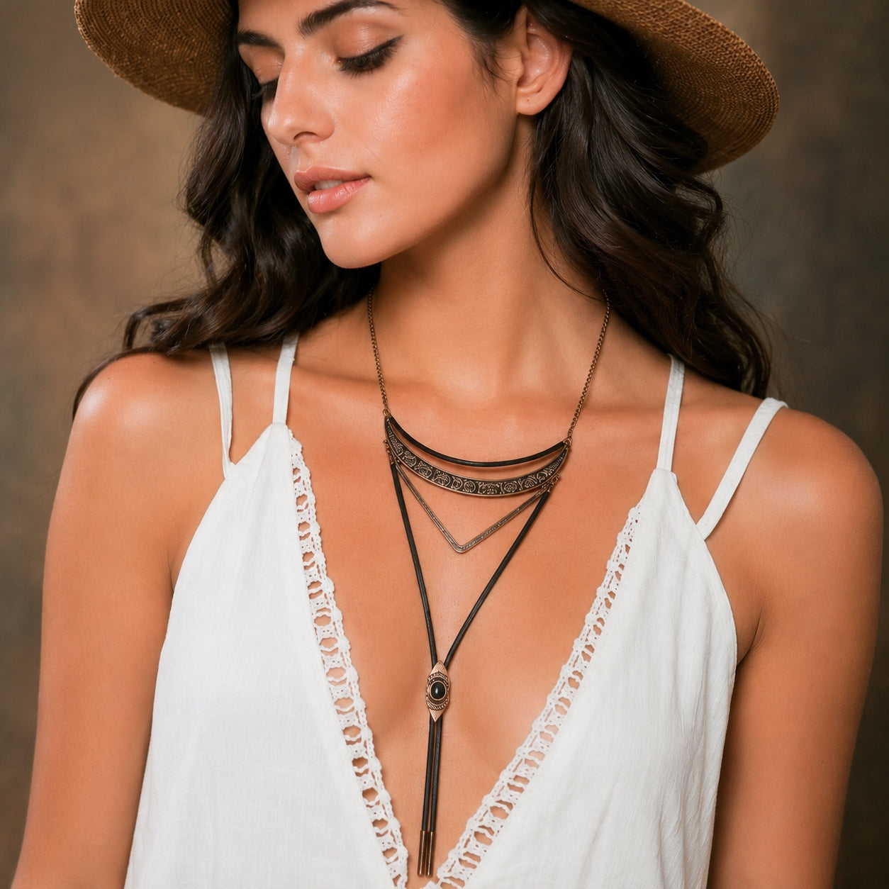 Woman wearing the Geometric Bolo Necklace in antique bronze with layered geometric pendant and black bolo cord.