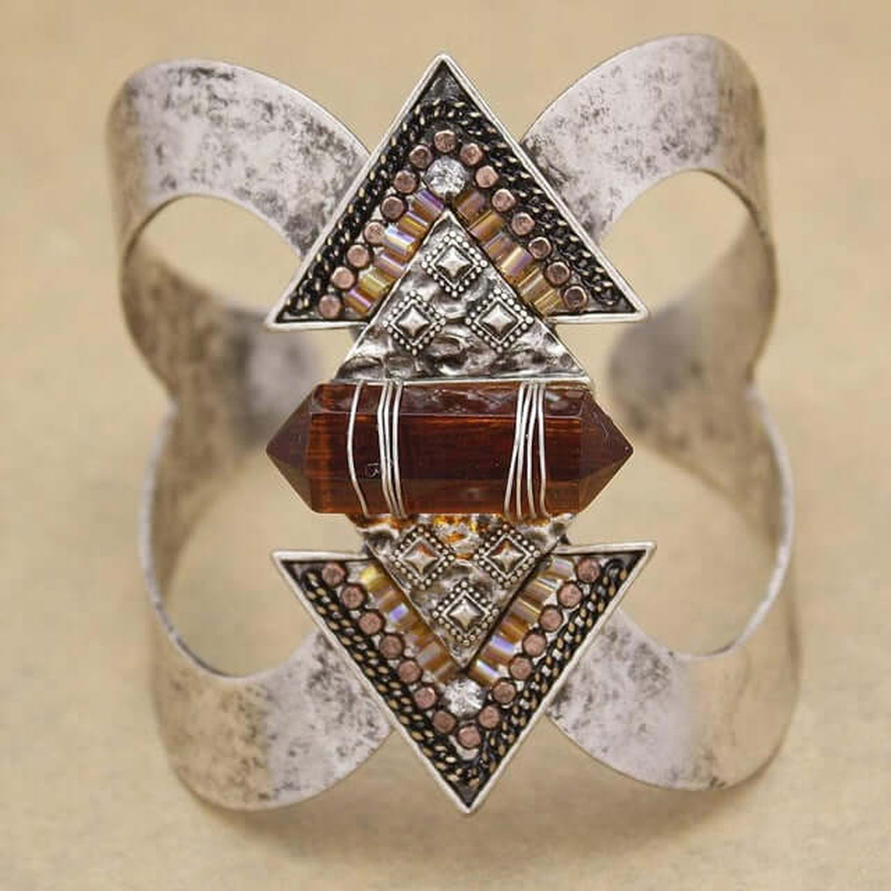 Front view of the Geometric Crystal Cuff Bracelet with antique silver finish, geometric triangle details, and amber crystal centerpiece.