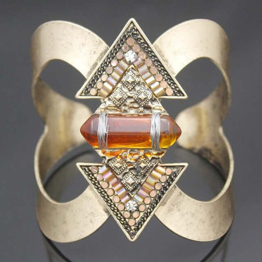 Geometric Crystal Cuff Bracelet in antique gold finish with geometric triangle accents, crystal embellishments, and amber gemstone centerpiece.