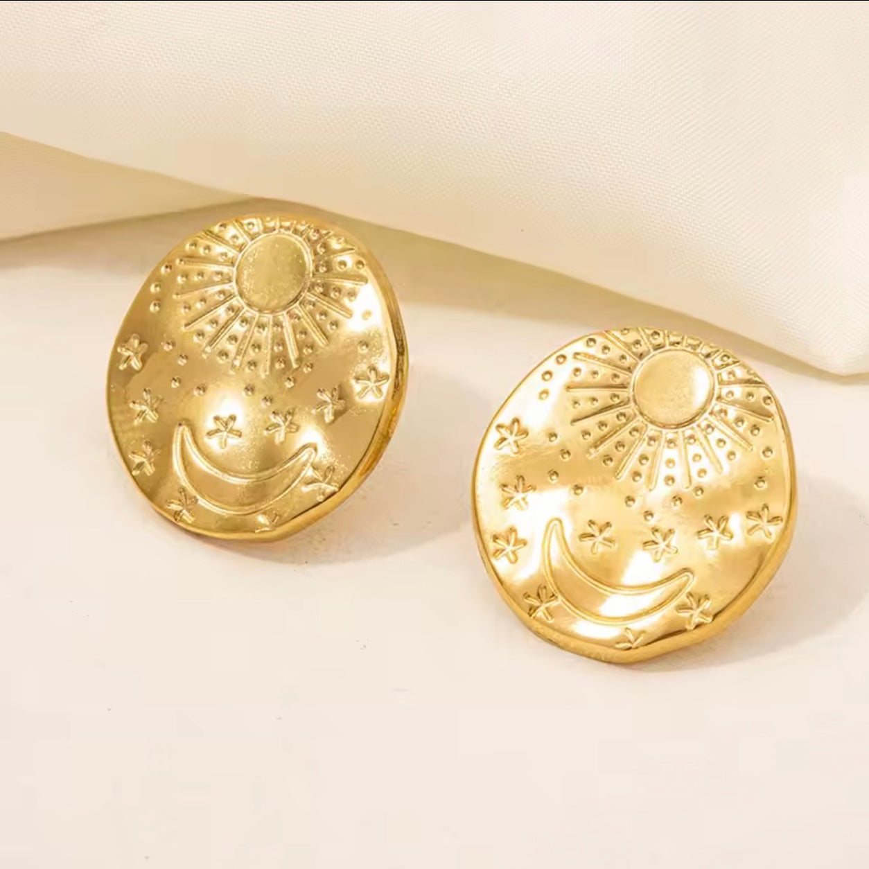 Gold Celestial Stud Earrings with sun, crescent moon and star design.