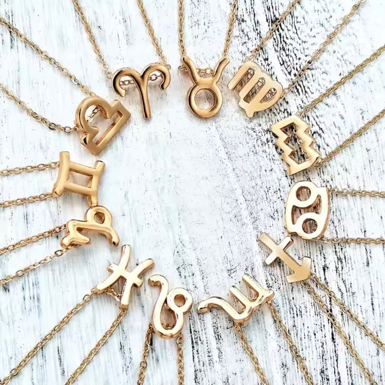 Gold Zodiac Necklace featuring all 12 zodiac sign pendants on delicate gold chains.