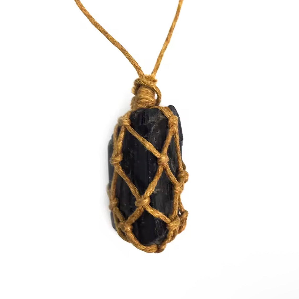 Back view of a hand-wrapped black tourmaline pendant showing the natural stone and woven cord detail.