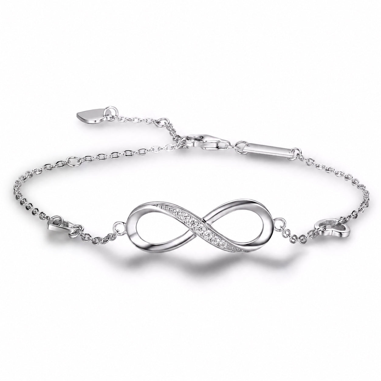 Front view of the Infinity Bracelet with polished infinity centerpiece, sparkling crystal accents, and adjustable heart chain on a white background.