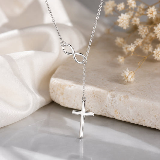 Infinity Cross Necklace in sterling silver featuring an infinity symbol and cross pendant displayed on a soft neutral background.