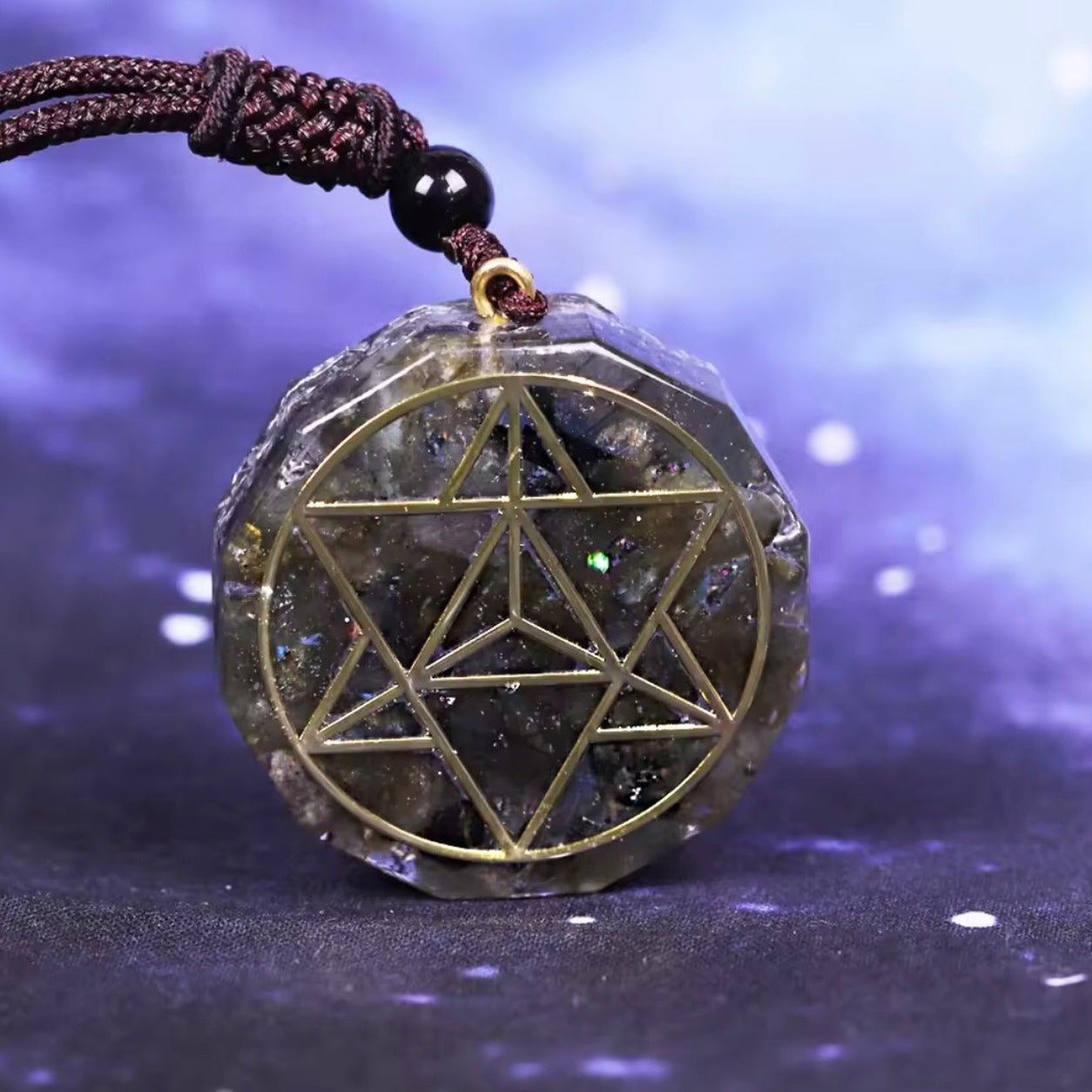 Close-up of a Labradorite Merkaba Pendant Necklace with gold sacred geometry detailing and natural labradorite flash.