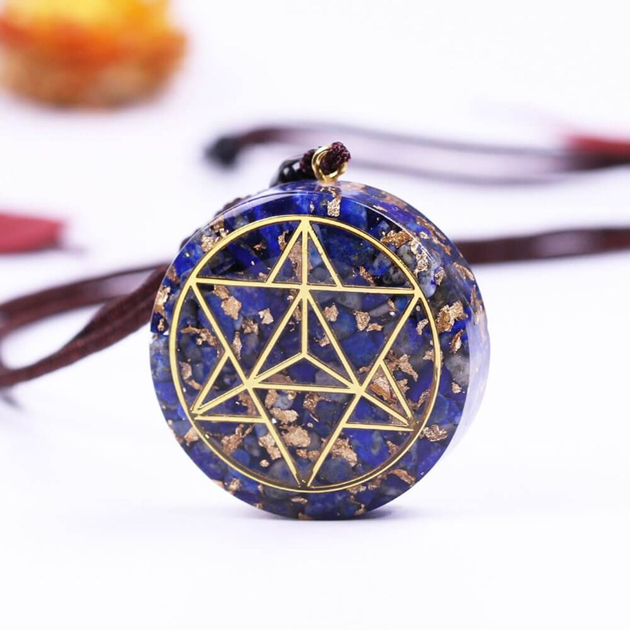 Angled view of the Lapis Lazuli Merkaba Pendant Necklace with polished lapis lazuli and geometric Merkaba symbol.