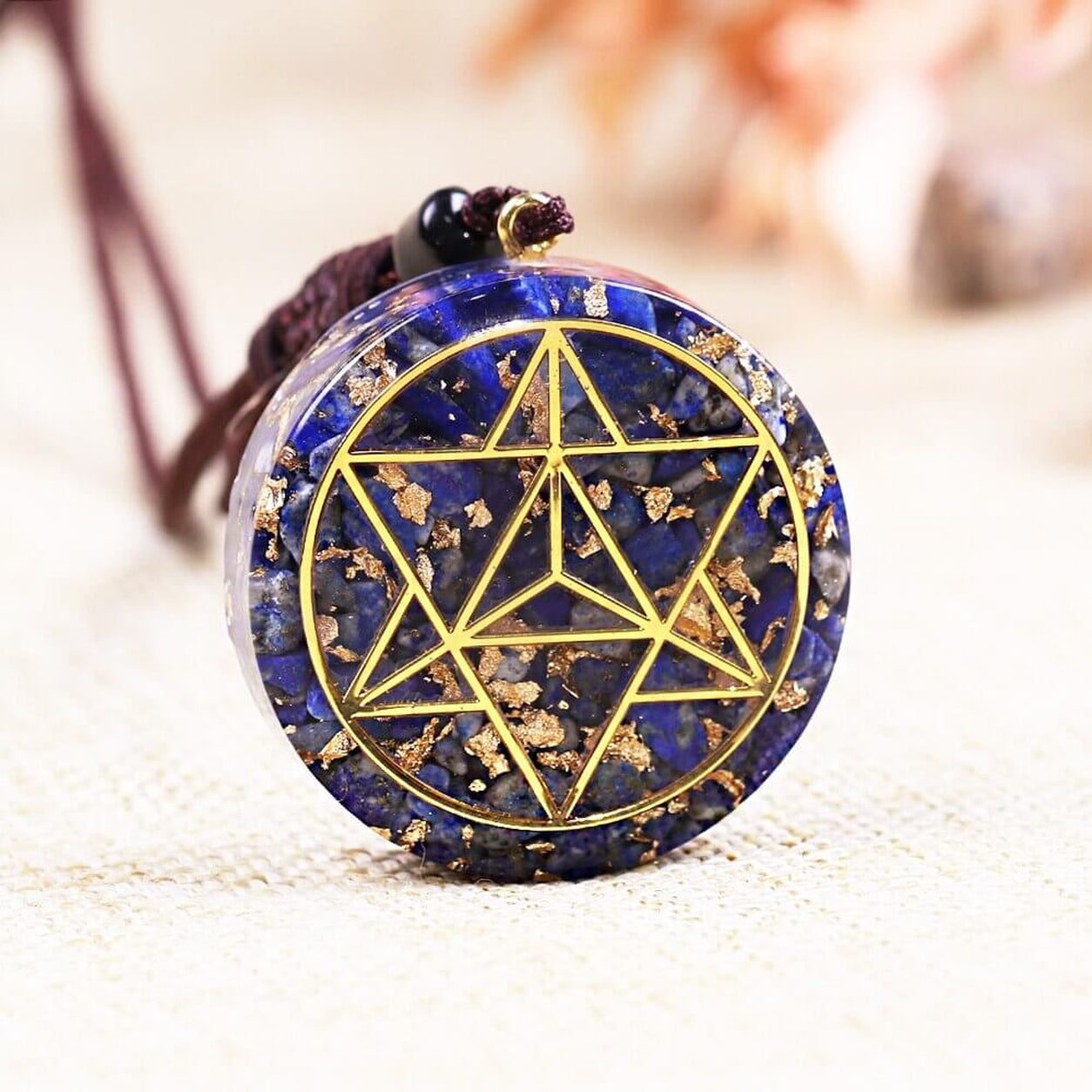 Close-up of the Lapis Lazuli Merkaba Pendant Necklace showcasing natural blue lapis stone and gold Merkaba design.