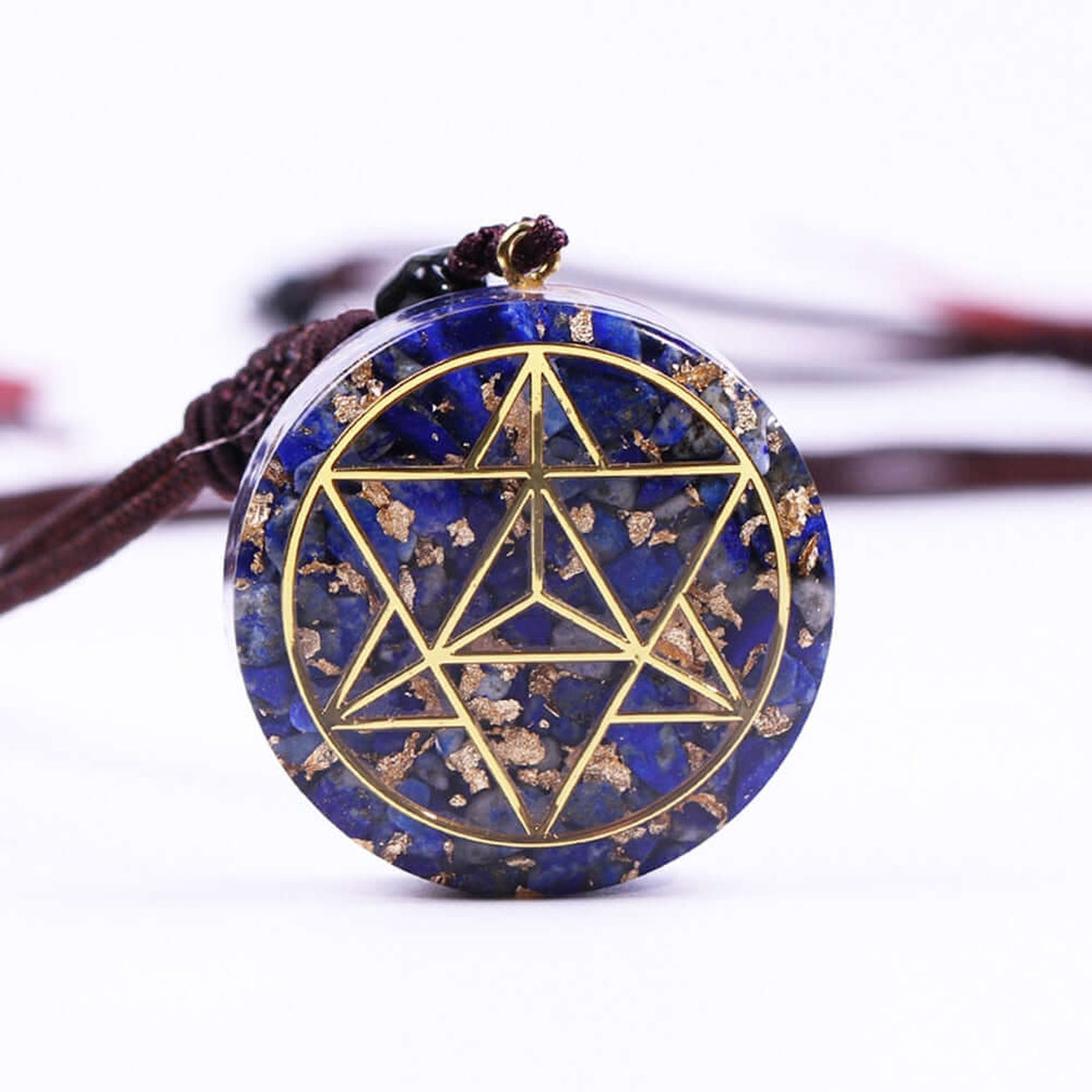 Lapis Lazuli Merkaba Pendant Necklace featuring natural lapis lazuli, gold sacred geometry, and adjustable cord.
