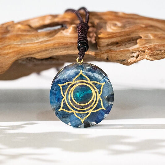 Lotus Kyanite Pendant Necklace featuring natural blue kyanite crystal in a round lotus pendant with an adjustable cord necklace.