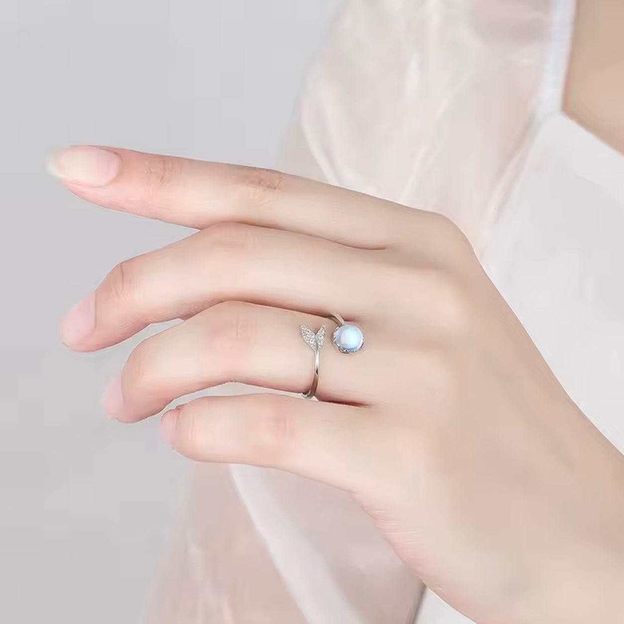 Mermaid Moonstone Ring worn on a hand, highlighting its minimalist silver design and luminous moonstone.