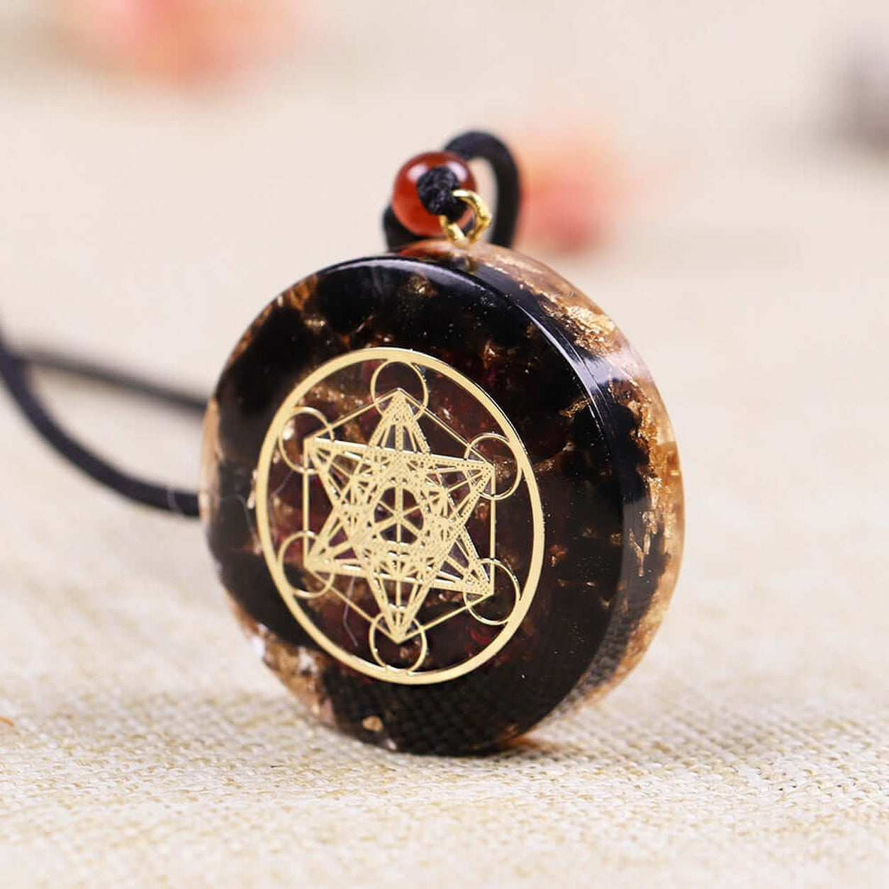 Angled view of Metatron’s Cube Obsidian Pendant Necklace with polished obsidian and detailed sacred geometry design.